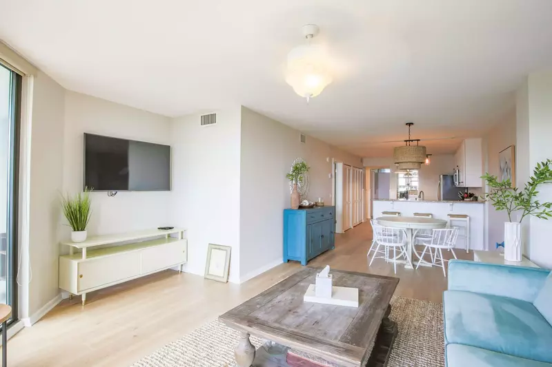 There is a wall-mounted smart TV in the living room.