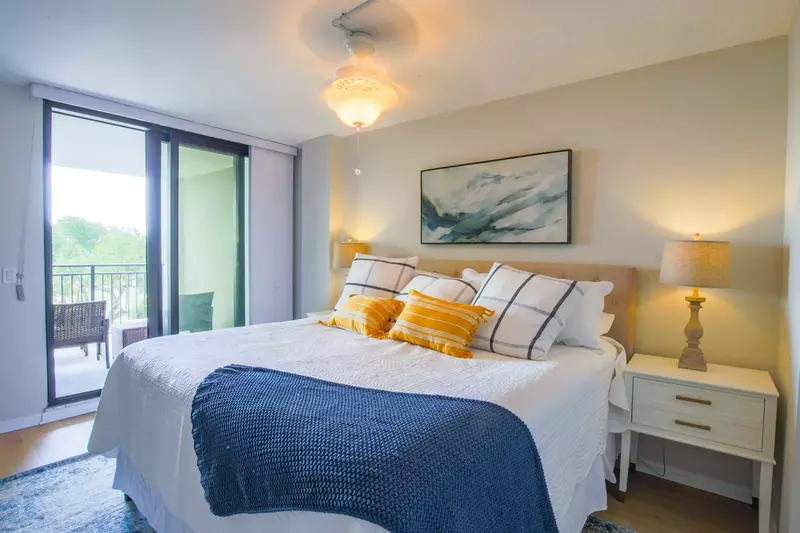 The master suite features a king bed and sliding door access to the covered balcony.