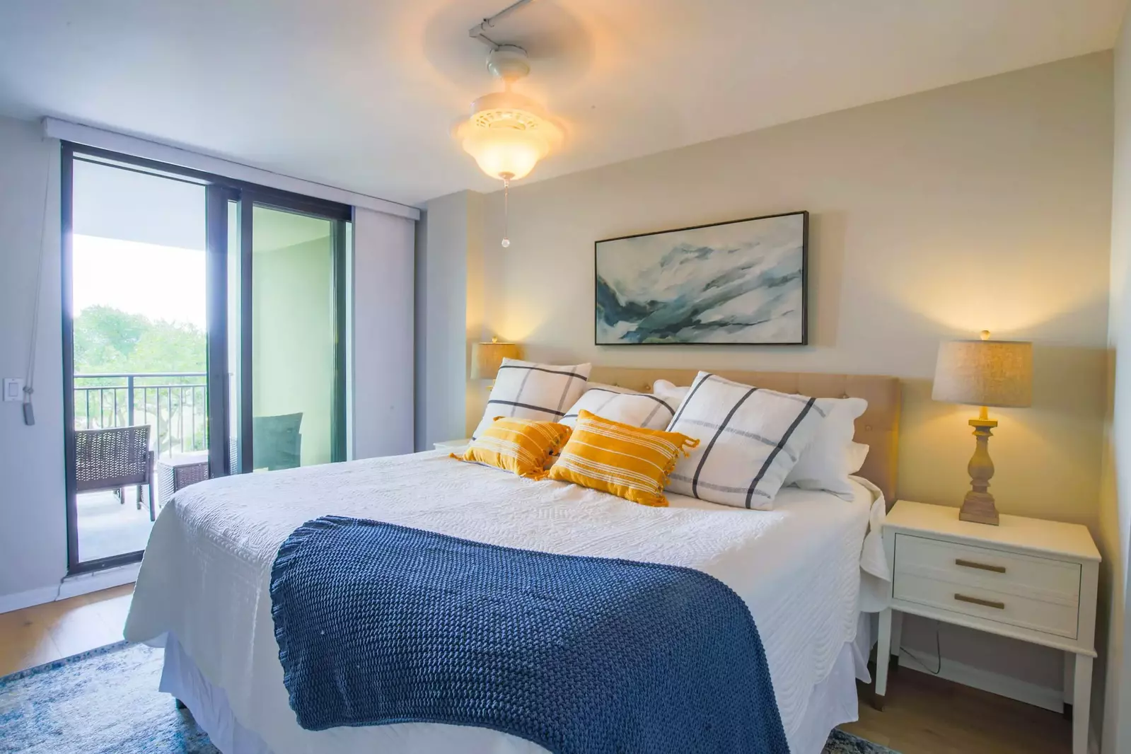 The master suite features a king bed and sliding door access to the covered balcony.