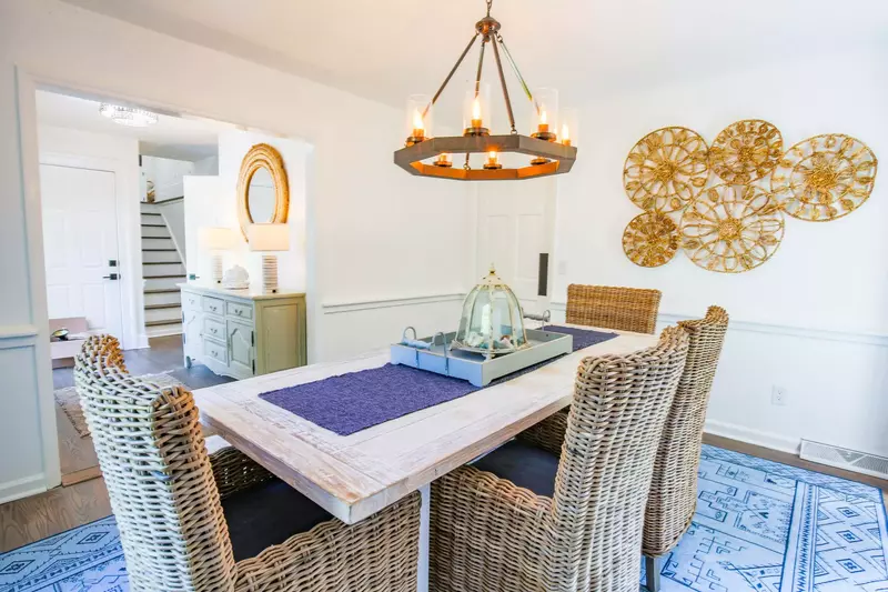 The dining room looks out into the foyer and is accessible from a swinging door in the kitchen.