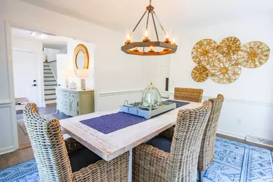 The dining room looks out into the foyer and is accessible from a swinging door in the kitchen.