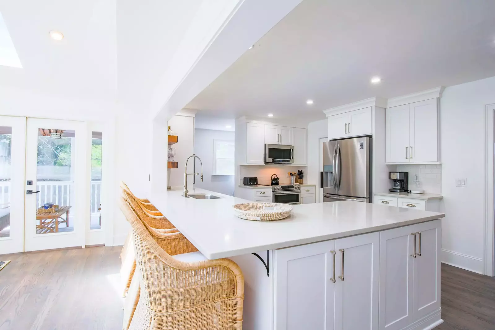 The kitchen features new countertops & cabinetry, stainless steel appliances and island seating.