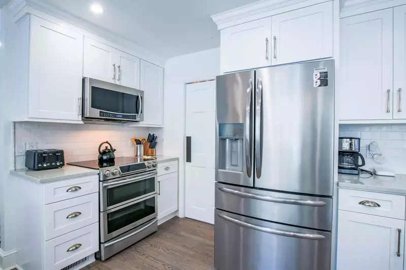 There is a double oven, microwave, refrigerator, drip coffee maker and toaster.
