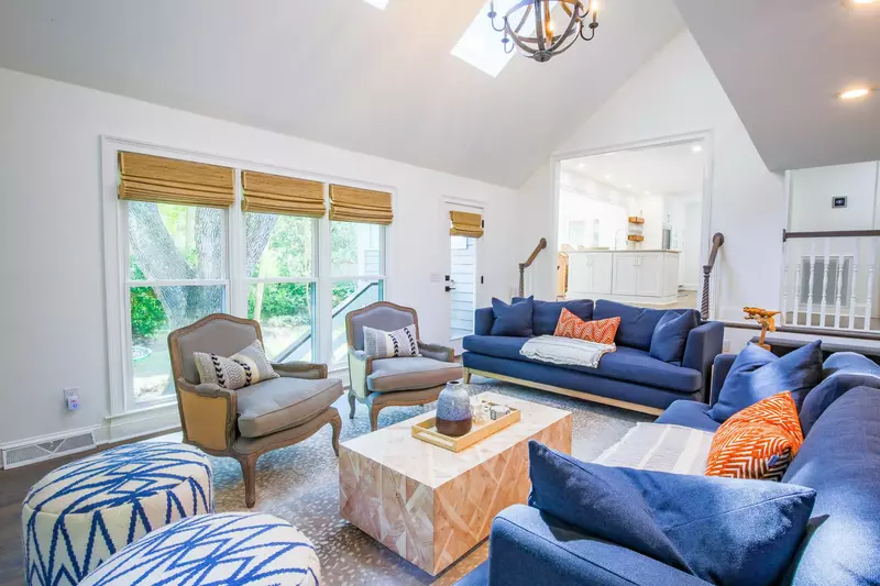 The living room features cathedral ceilings and a large, comfortable seating area.