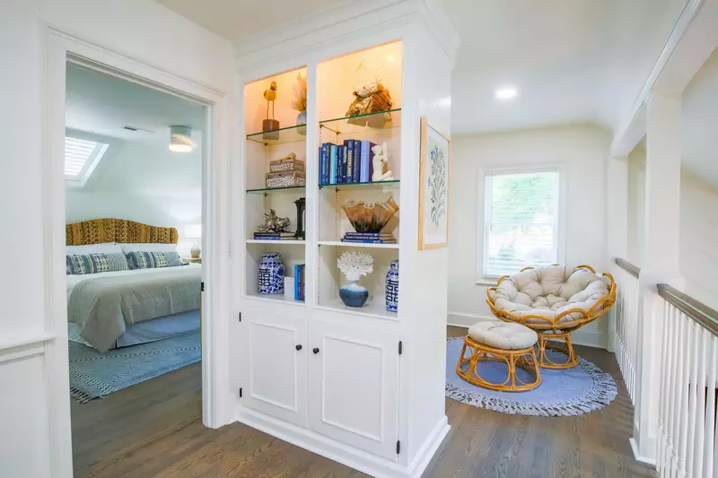 You'll find this built-in bookshelf and balcony overlooking the living room below at the top of the stairs on the second floor.
