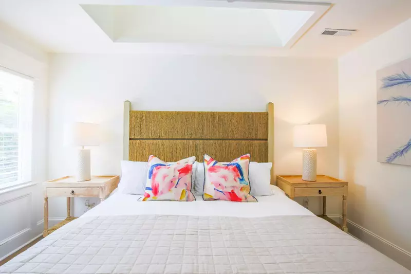 The master suite features a king bed and night stands with reading lamps.
