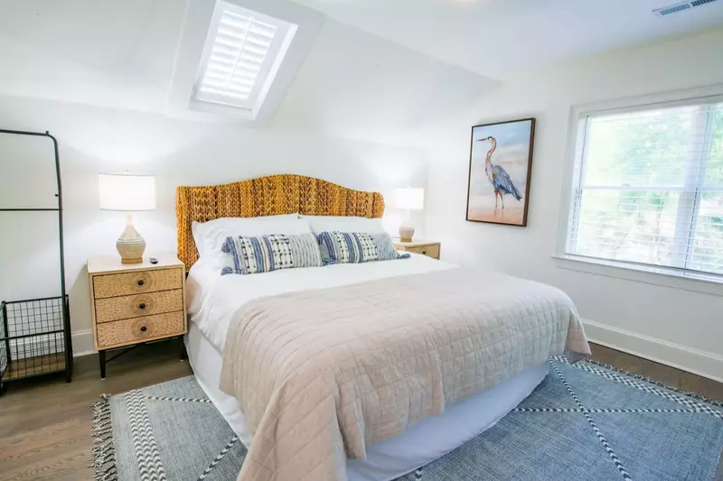 The second master suite has a king bed and night stands with reading lamps.