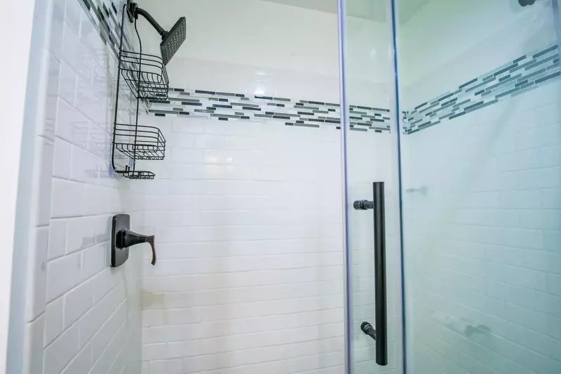 The en suite bathroom also features a tiled, walk-in shower.