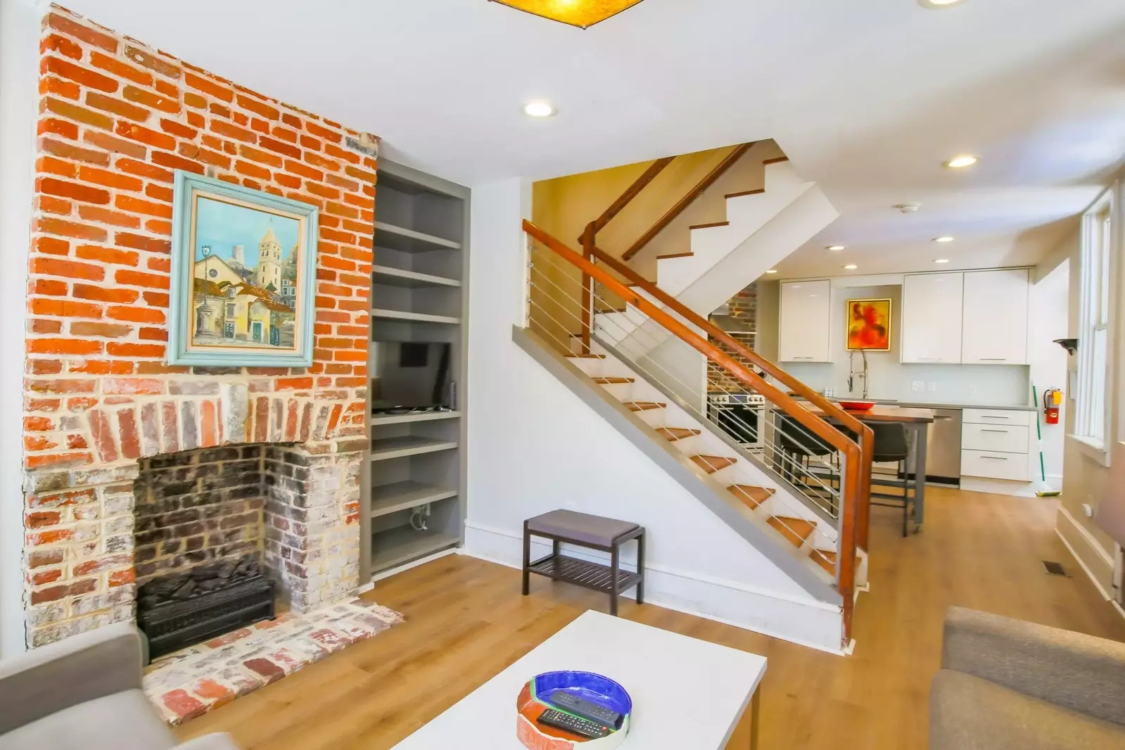 The staircase to the second floor divides the living room and kitchen areas.