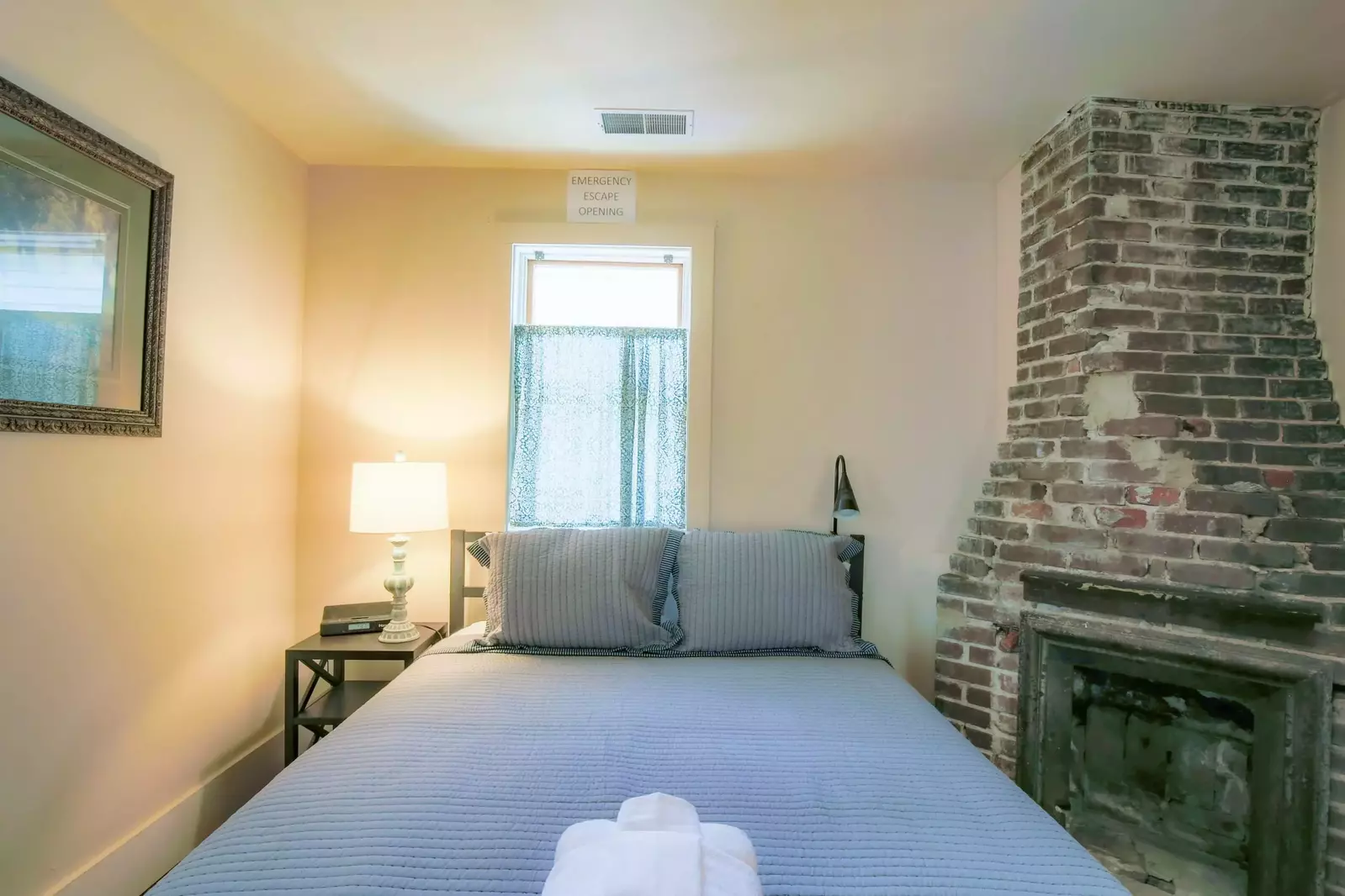 The master suite features a king bed and night stand with reading lamps.