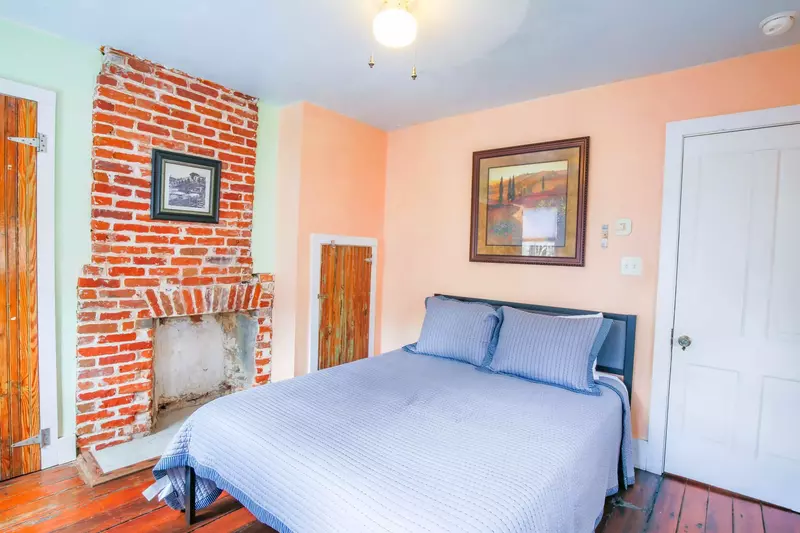 The fireplace is non-functional and there is no closet space available for guest use in this bedroom.