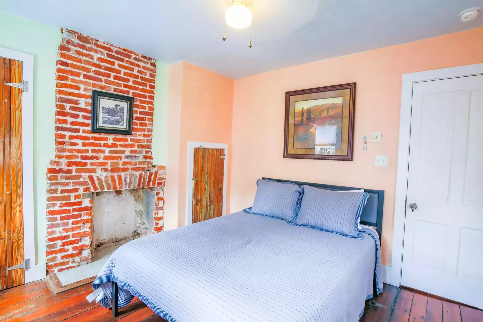 The fireplace is non-functional and there is no closet space available for guest use in this bedroom.