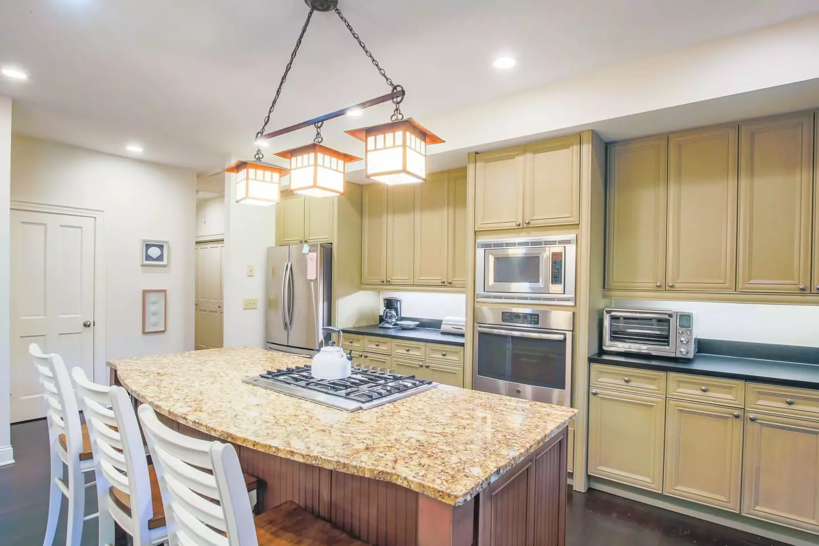 The kitchen features a gas cooktop, oven, microwave, refrigerator, drip coffee maker and toaster oven.