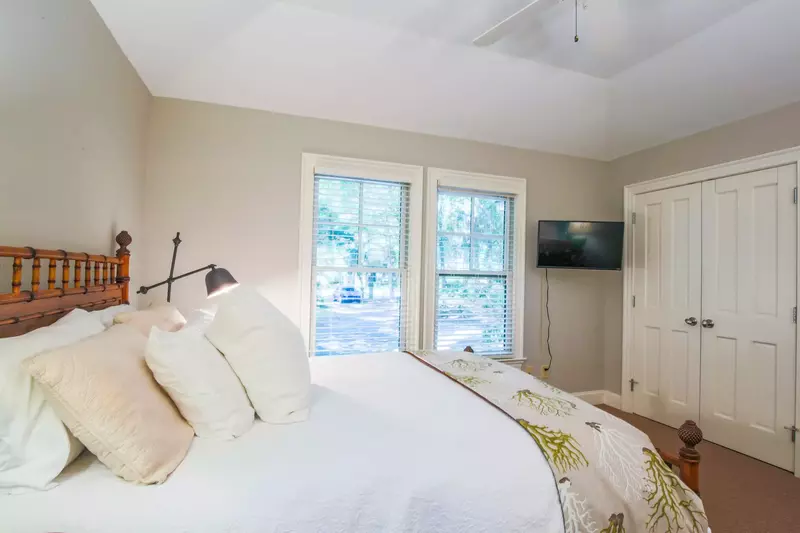 This bedroom looks out onto the driveway and front yard.
