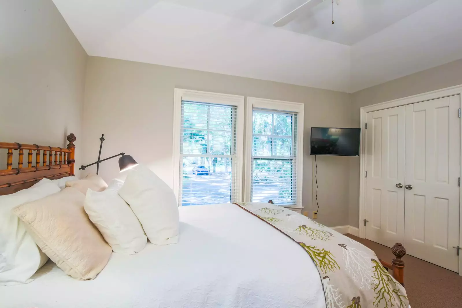 This bedroom looks out onto the driveway and front yard.