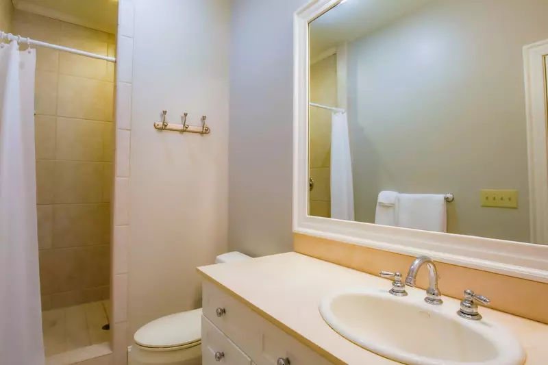 The en suite bathroom features a tiled, walk-in shower and a spacious vanity.