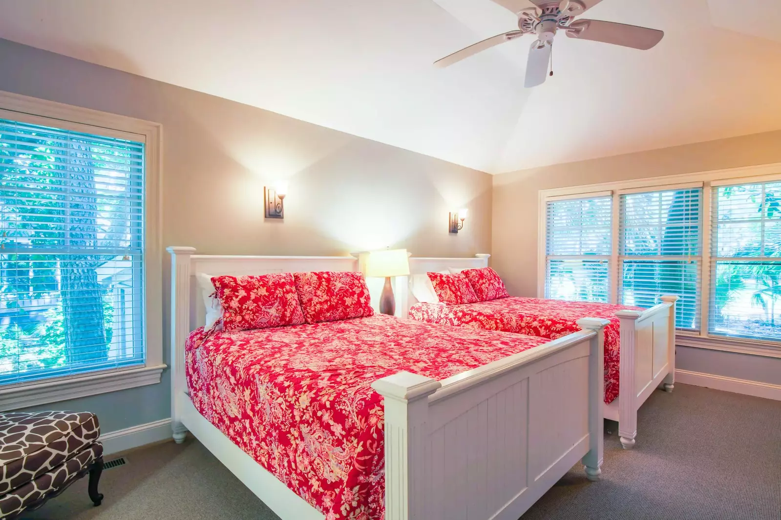 This guest bedroom features two queen beds and golf course views.