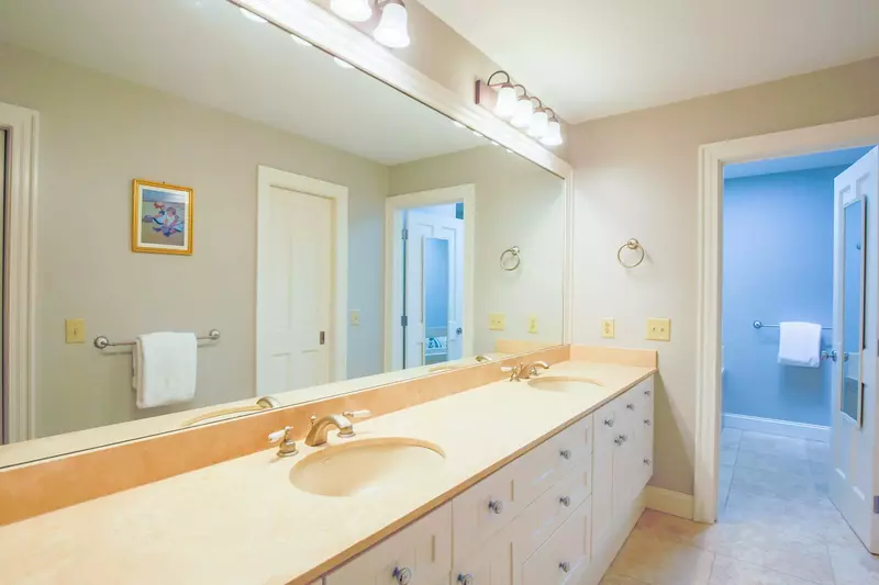 The en suite bathroom features a double sink vanity with lots of countertop & cabinet storage space.