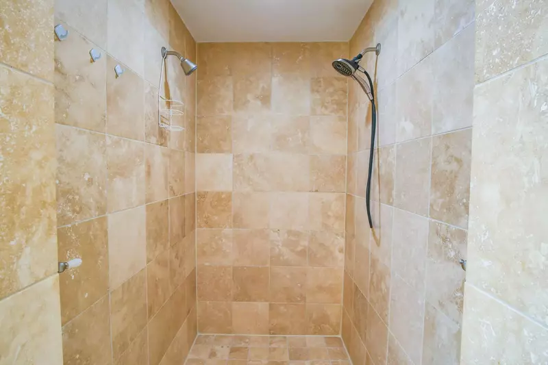 The en suite bathroom also features this large, walk-in shower with two shower heads.