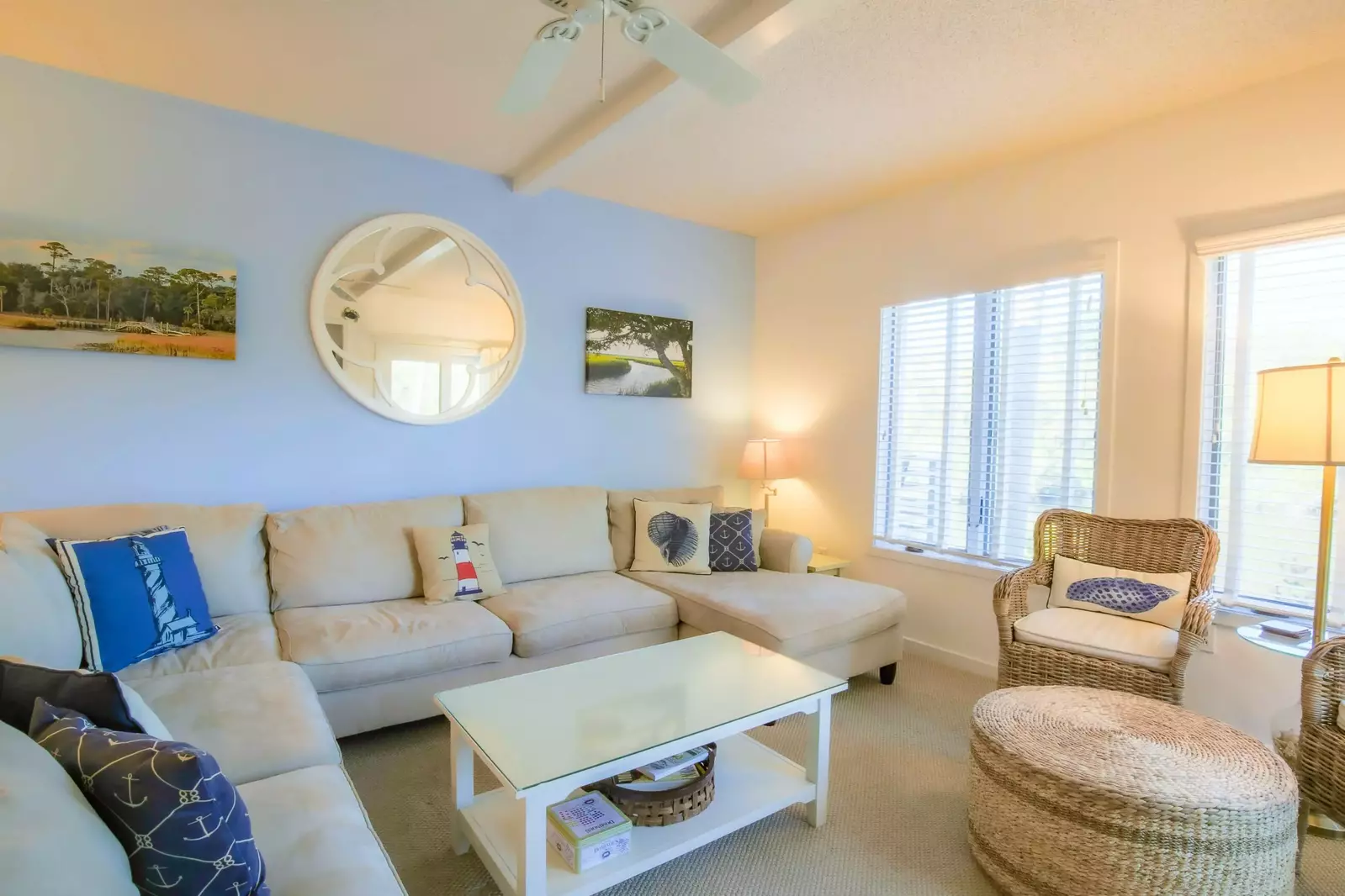 The living room has a large sectional sofa and two arm chairs.