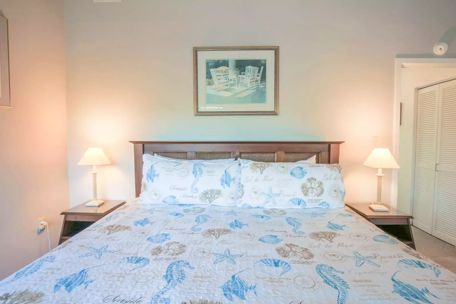 The master suite, which is located on the home's upper level, features a king bed and night stands with reading lamps.