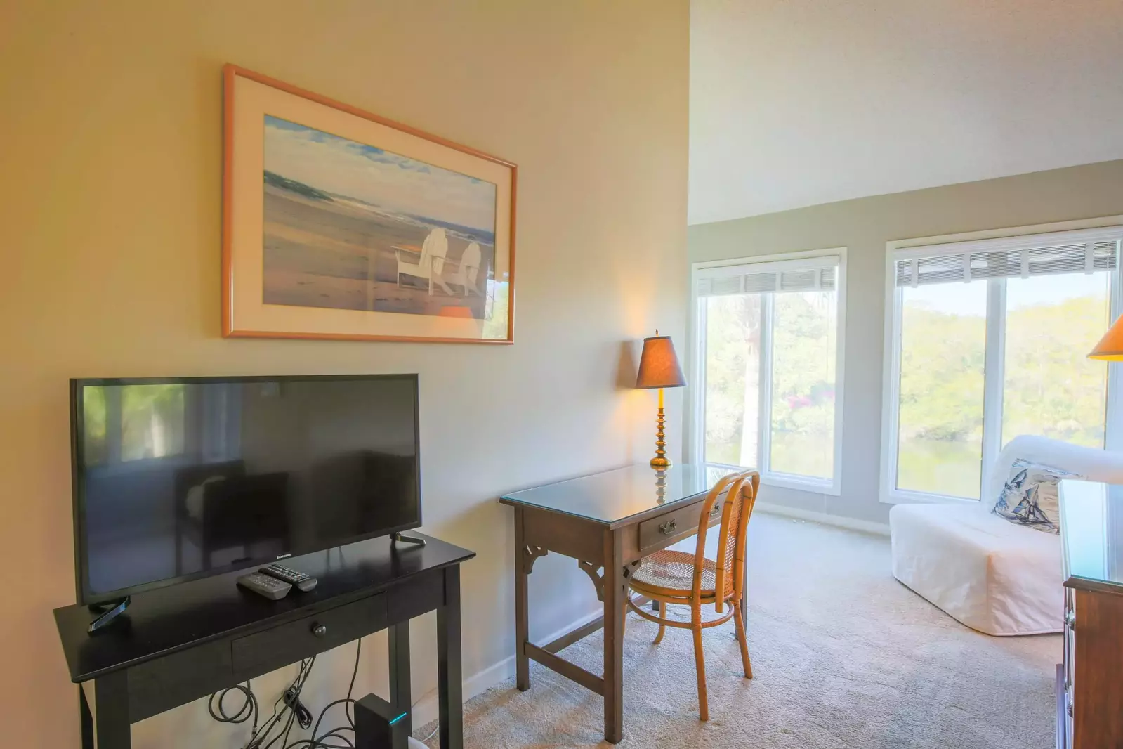 The master suite has a cable TV, desk, dresser and seating area.