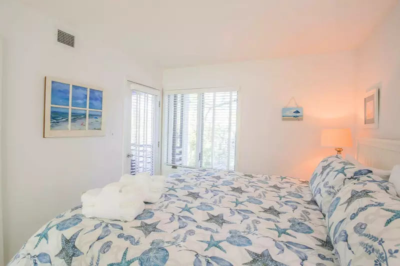 This bedroom also has access to the screened porch.