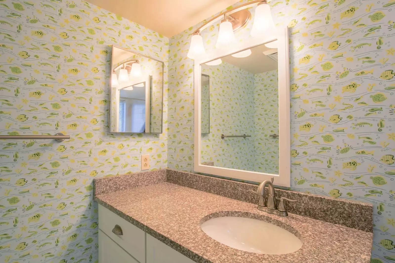 The en suite bathroom has a large vanity.