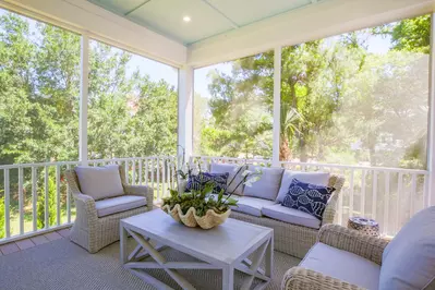 Whispering Palms features this wonderful screened porch.