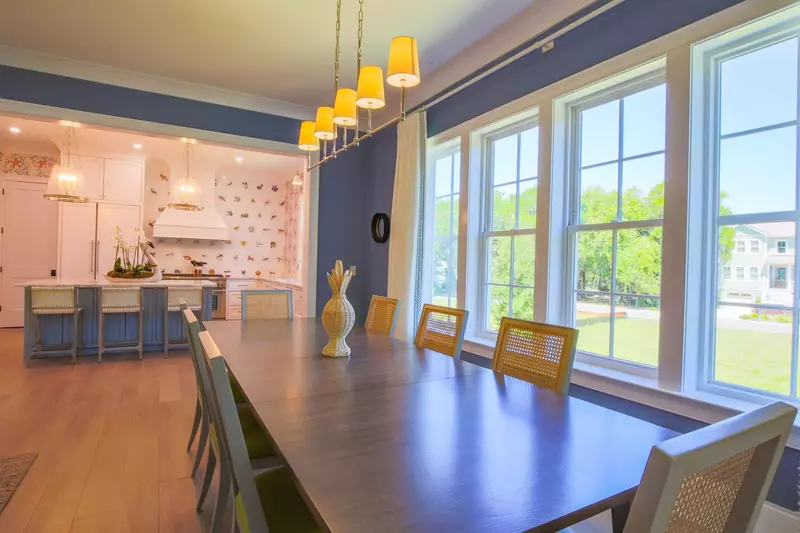 The dining table comfortably seats 8 and there are 3 stools at the kitchen island.