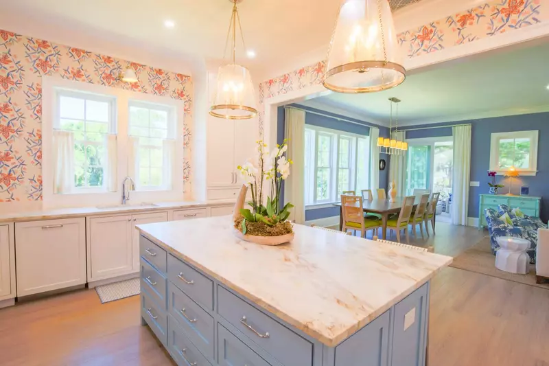 The kitchen features a center island with marble counters.
