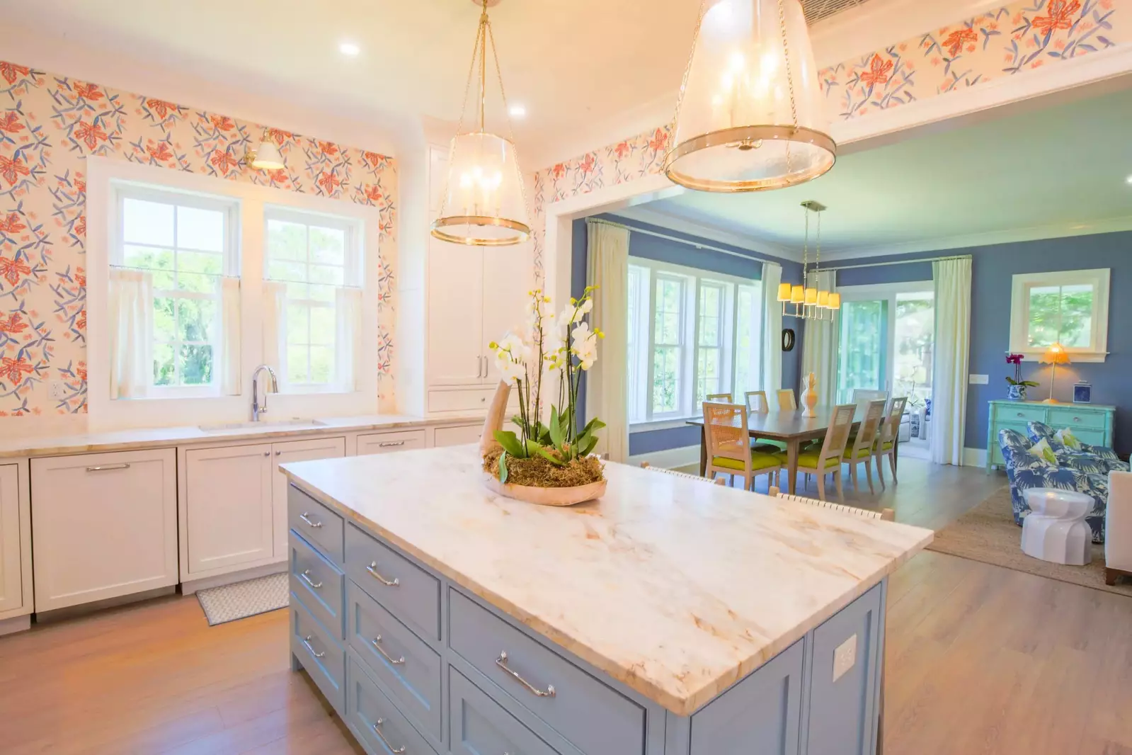 The kitchen features a center island with marble counters.