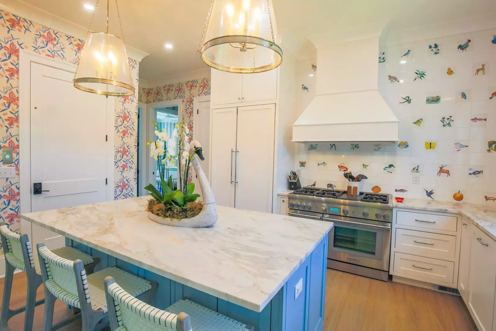 The kitchen features top of the line appliances, including a Thermador refrigerator and double oven range.