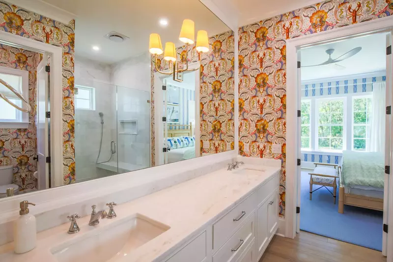The en suite bathroom features a double sink vanity with lots of countertop & cabinet storage space.