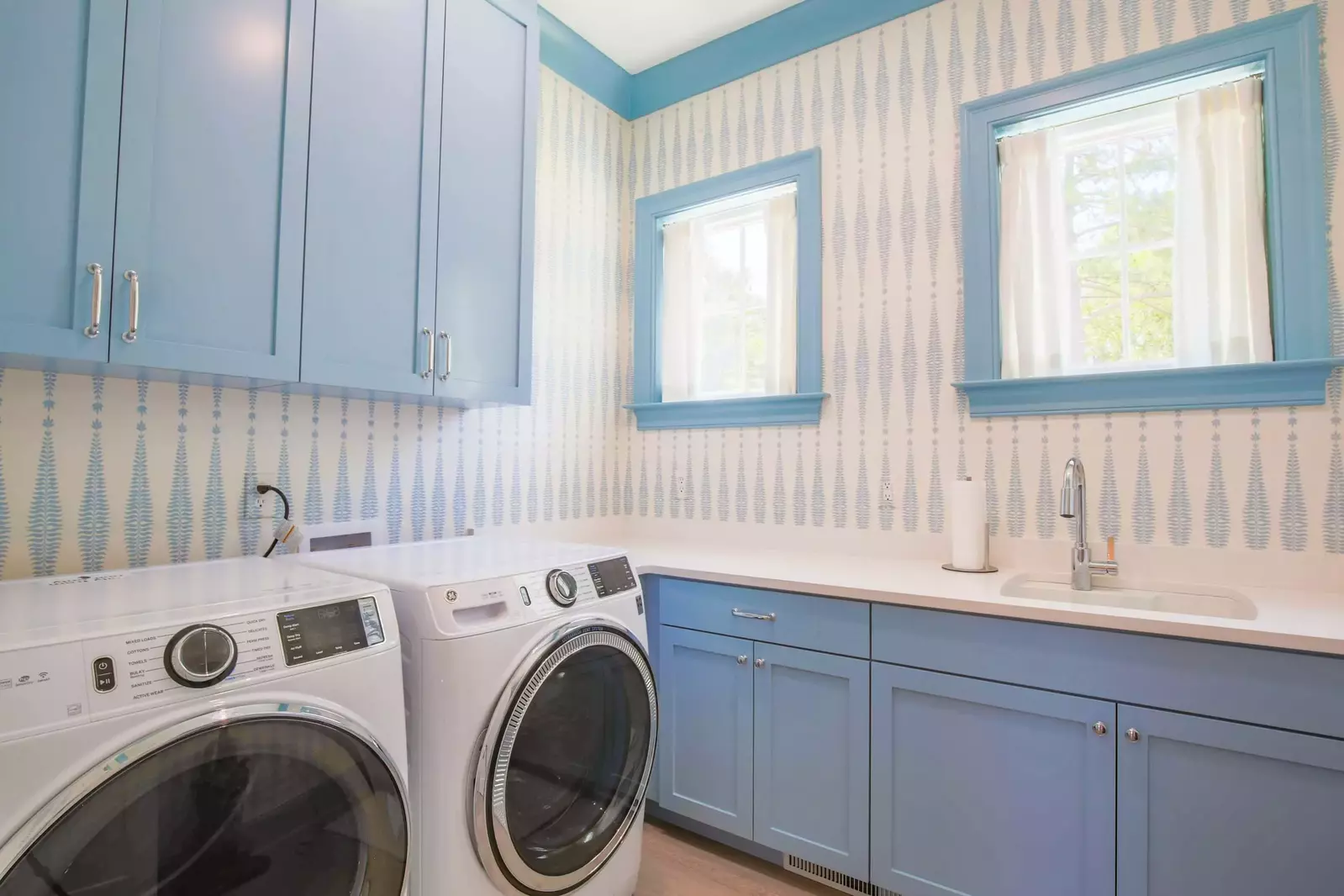 Whispering Palms has a spacious laundry room with a washing machine, dryer and utility sink.