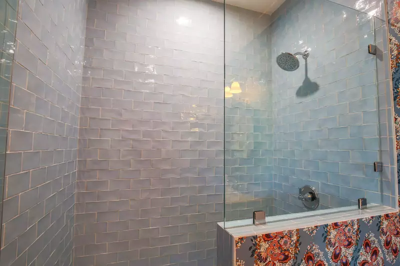 This en suite bathroom also has tiled, walk-in shower.