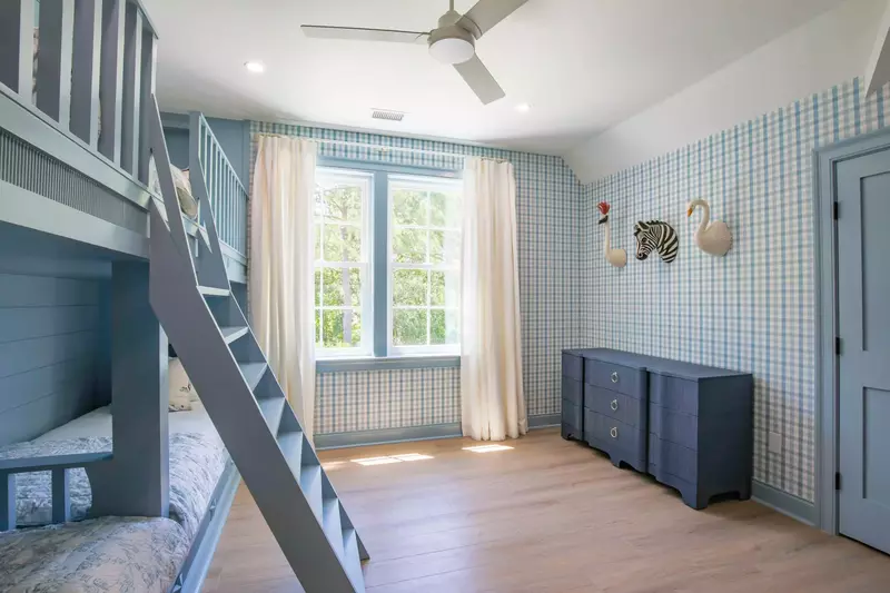 The bunk bedroom also has a dresser, lovely natural light and shared access to a Jack & Jill bathroom.