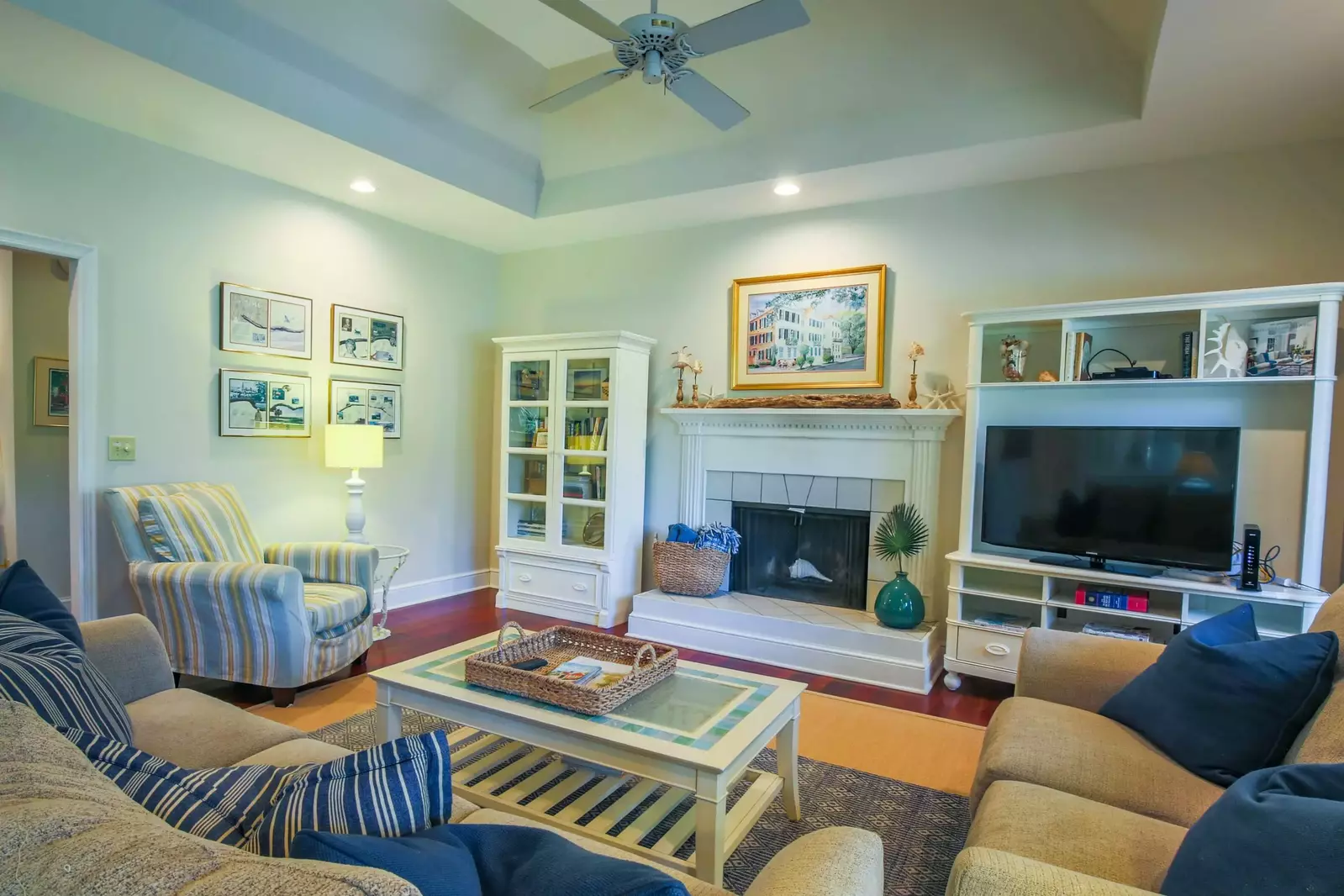 The living room features vaulted ceilings, a large screen TV and comfortable furnishings.