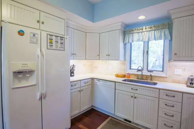 The kitchen has a refrigerator, dishwasher, garbage disposal, toaster and range.