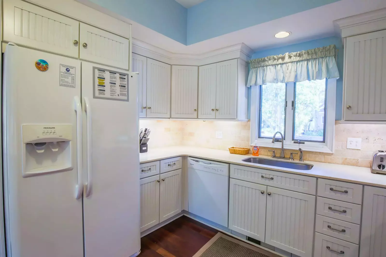 The kitchen has a refrigerator, dishwasher, garbage disposal, toaster and range.