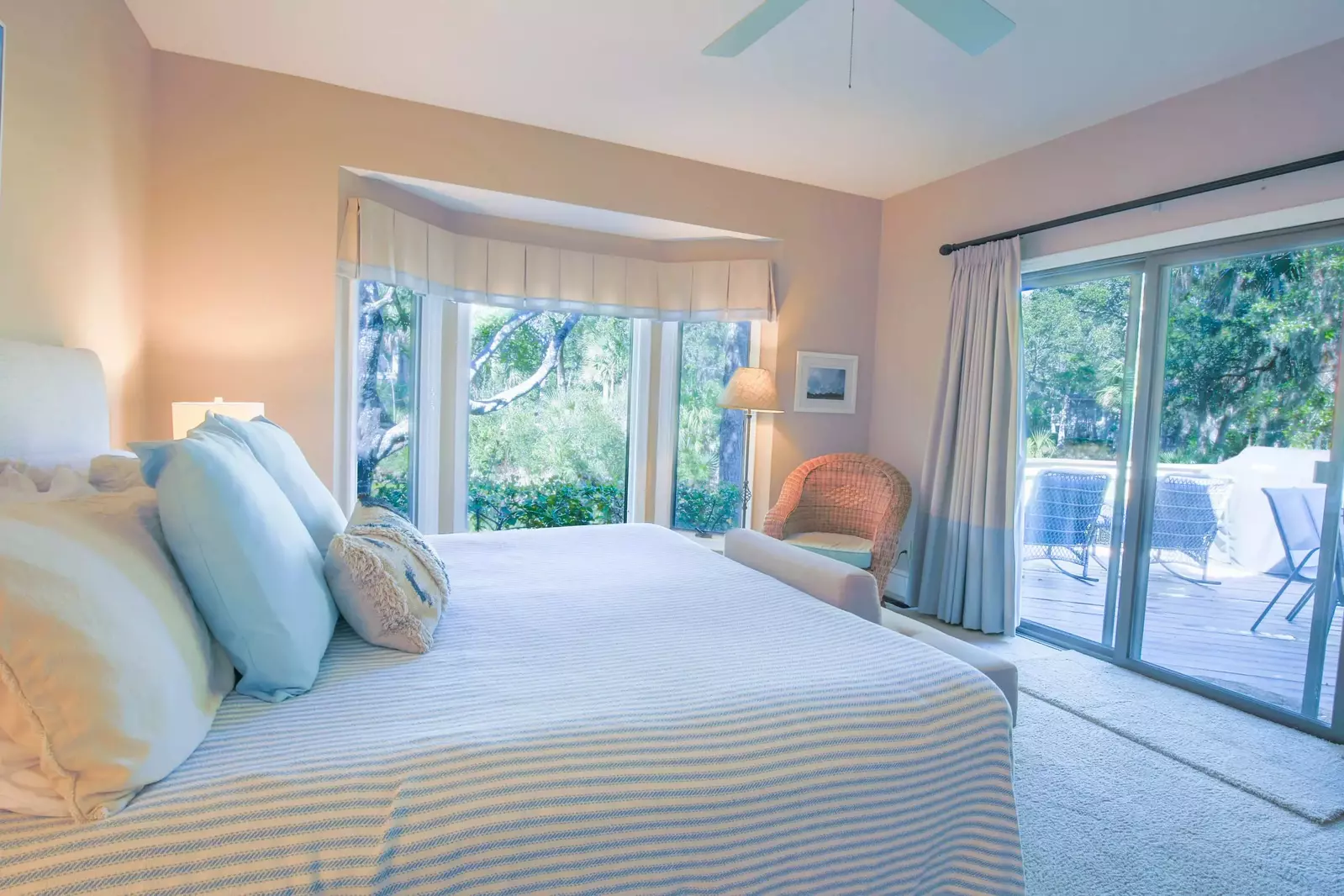 The primary suite features a king bed, access to the back porch and water views of the lagoon.