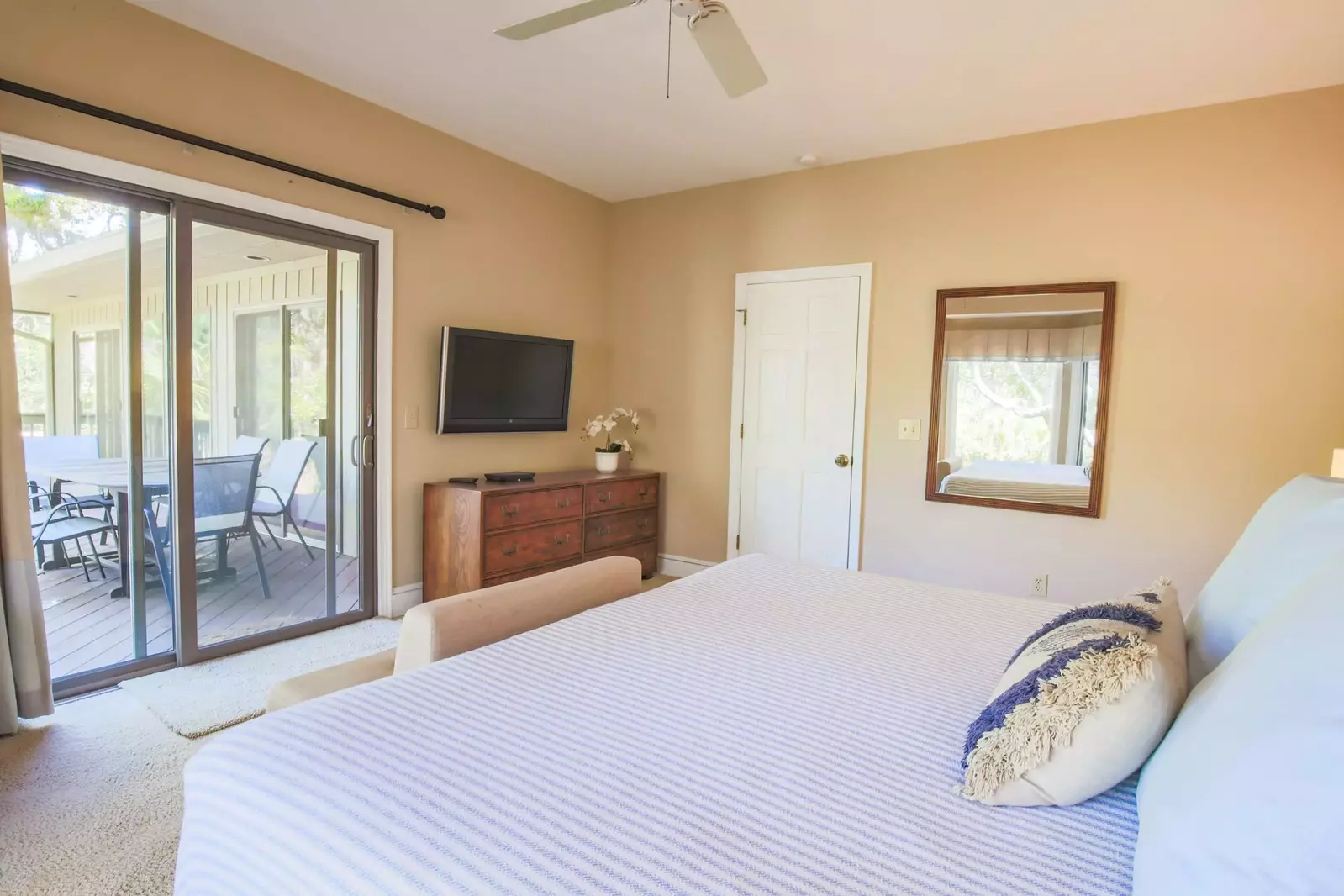 The primary suite also has a dresser and wall-mounted cable TV.