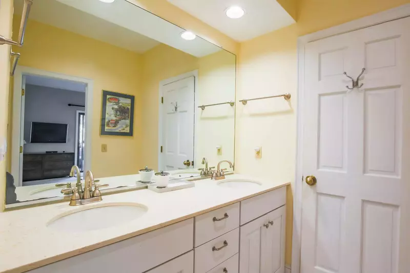 The primary bathroom has a double sink vanity.