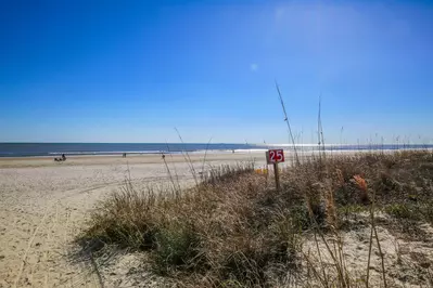 Follow the beach access point pathway adjacent to the house and you'll be on the beach in no time!