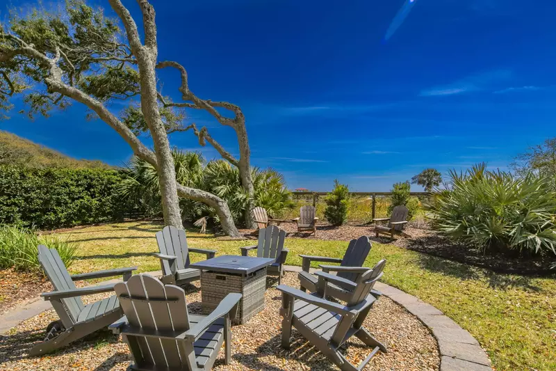 There are Adirondack seating areas in the backyard.