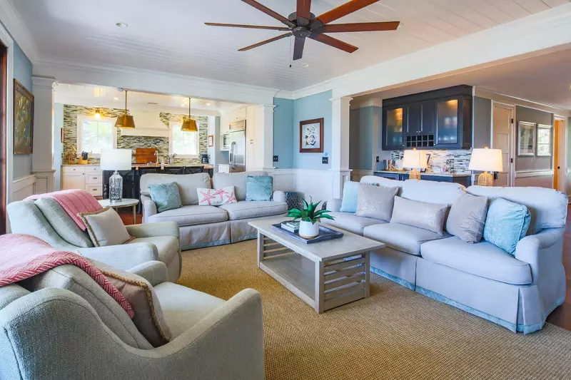 This comfortable living room connects to the back porch and the kitchen.