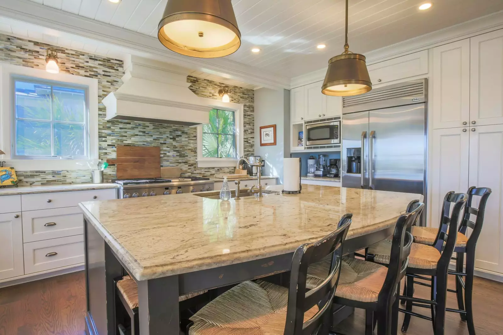 The kitchen centers around the island with granite counters, pendant lighting and 6 stools.