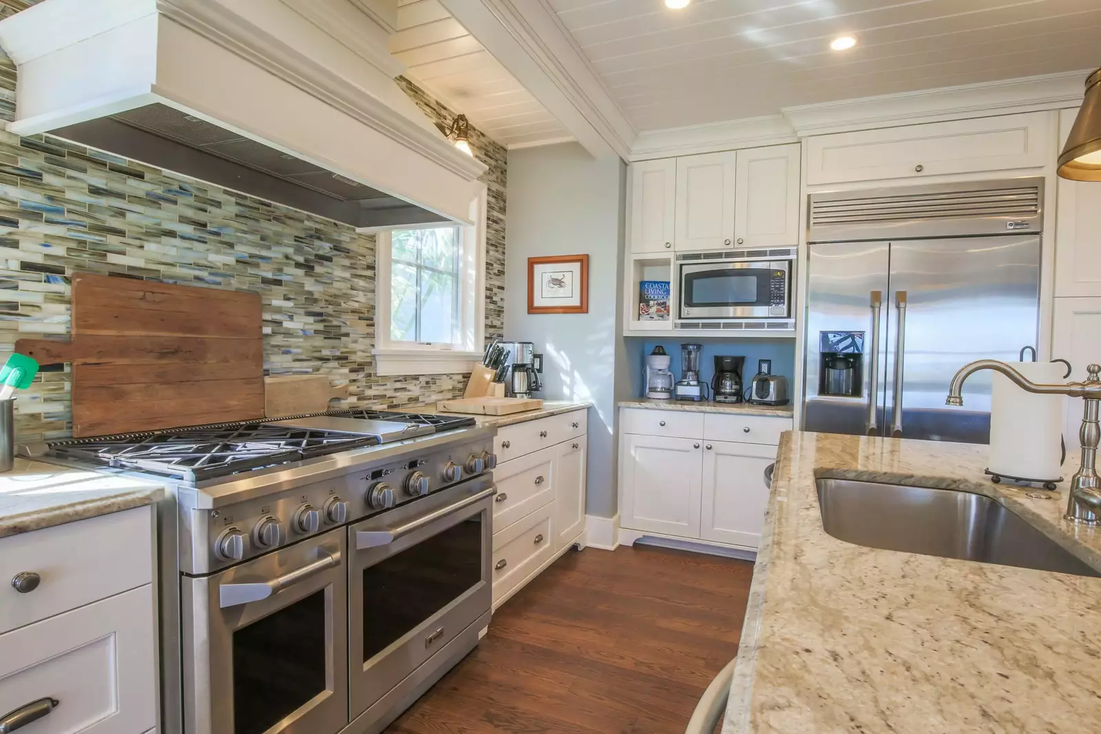 The kitchen features stainless steel appliances, including a gourmet range, built-in refrigerator and two dishwashers.