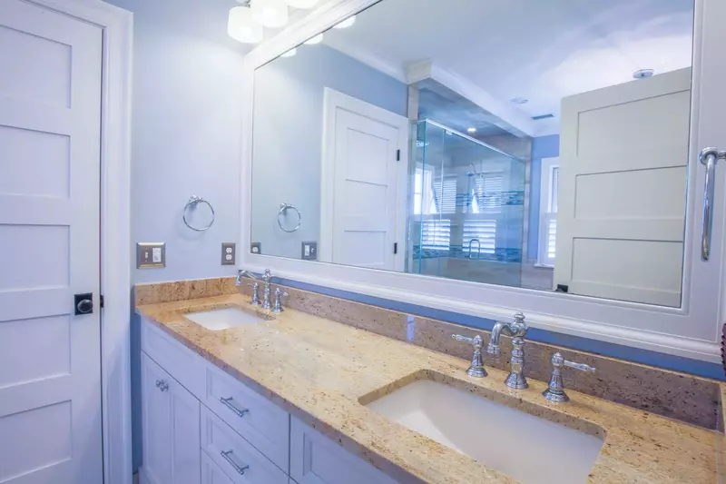 The master bathroom features a spacious, double sink vanity.