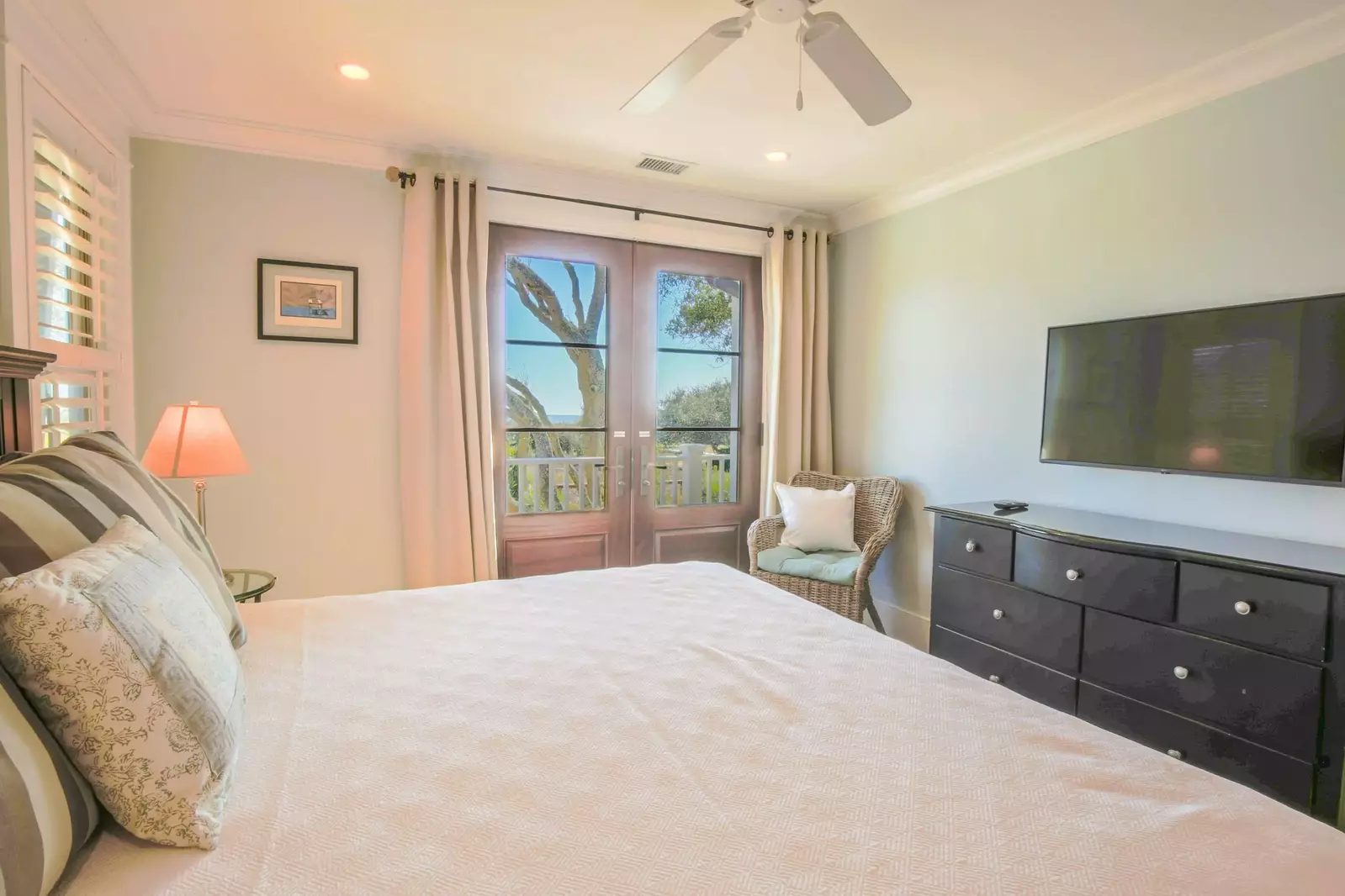 This master suite on the home's lower level also has a king bed, dresser and mounted TV.
